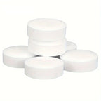 Set of gray espresso machine cleaning tablets, three stacked