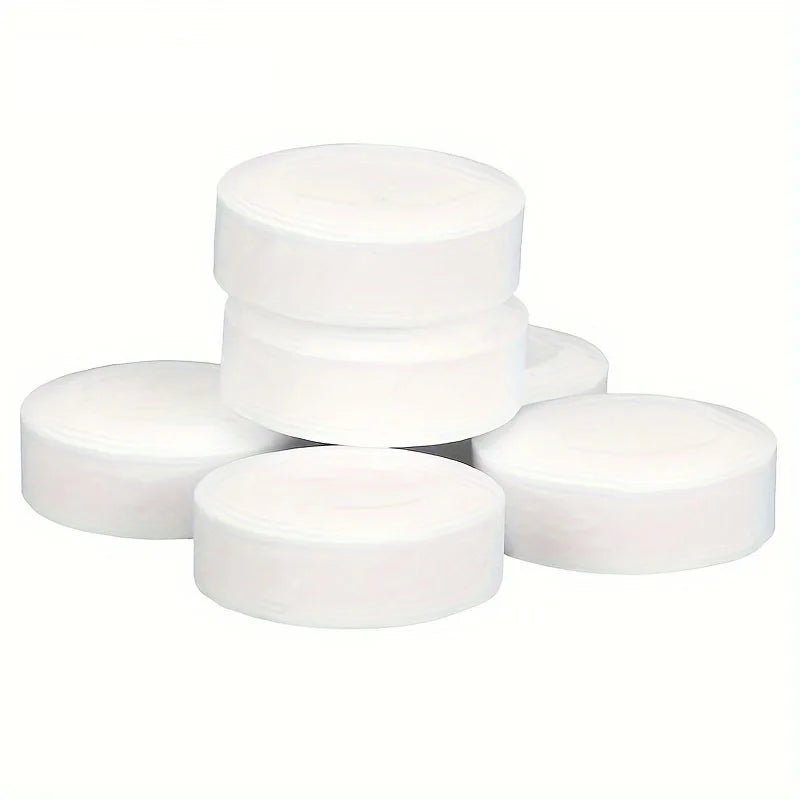 Set of gray espresso machine cleaning tablets, three stacked
