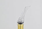 Clear wine pourer aerator tip attached to bottle neck, angled nozzle