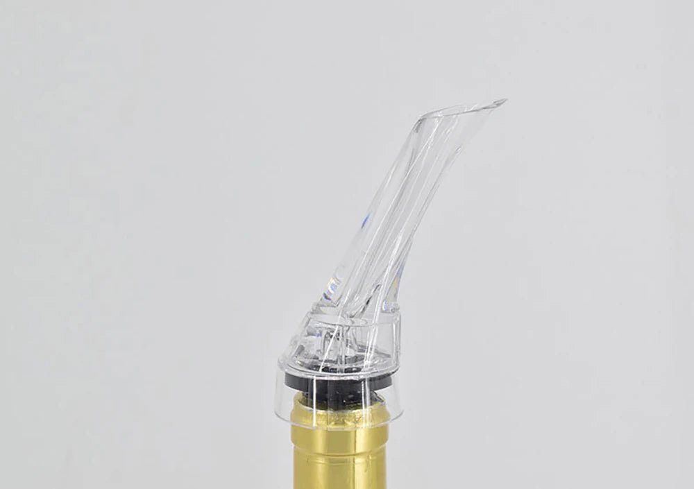 Clear wine pourer aerator tip attached to bottle neck, angled nozzle
