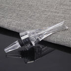 Wine aerator pourer spout with clear tube and black connector, shown alongside bottle