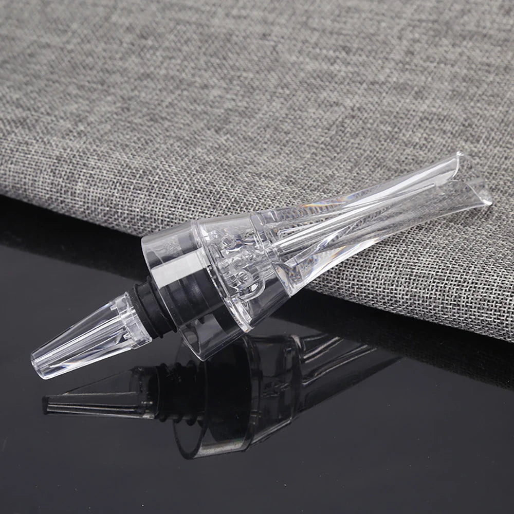 Wine aerator pourer spout with clear tube and black connector, shown alongside bottle