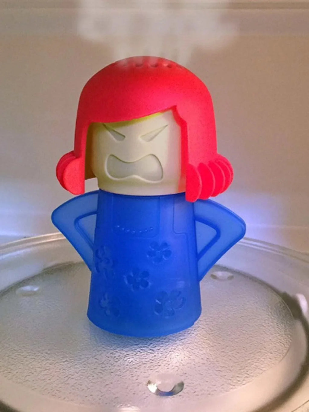 Microwave steam cleaner with red hood and blue base, shown over a plate.