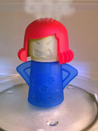 Microwave steam cleaner with red hood and blue base, shown over a plate.