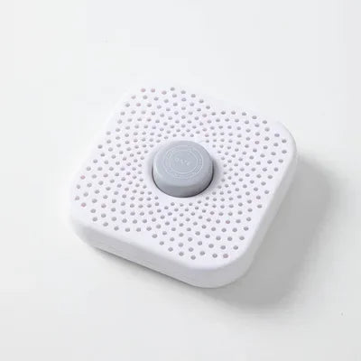 White refrigerator deodorizer box with perforated surface and gray date button