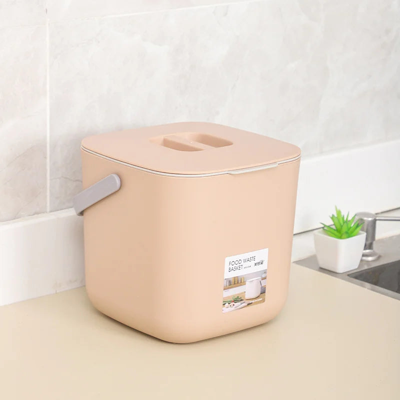 Large beige countertop food waste bin with lid opening and side carry handle