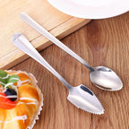 Two stainless steel spoons with micro-serrated tips for citrus carving on wood