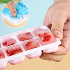 Sky blue silicone ice cube tray with lid, showing red ice cubes in molded wells