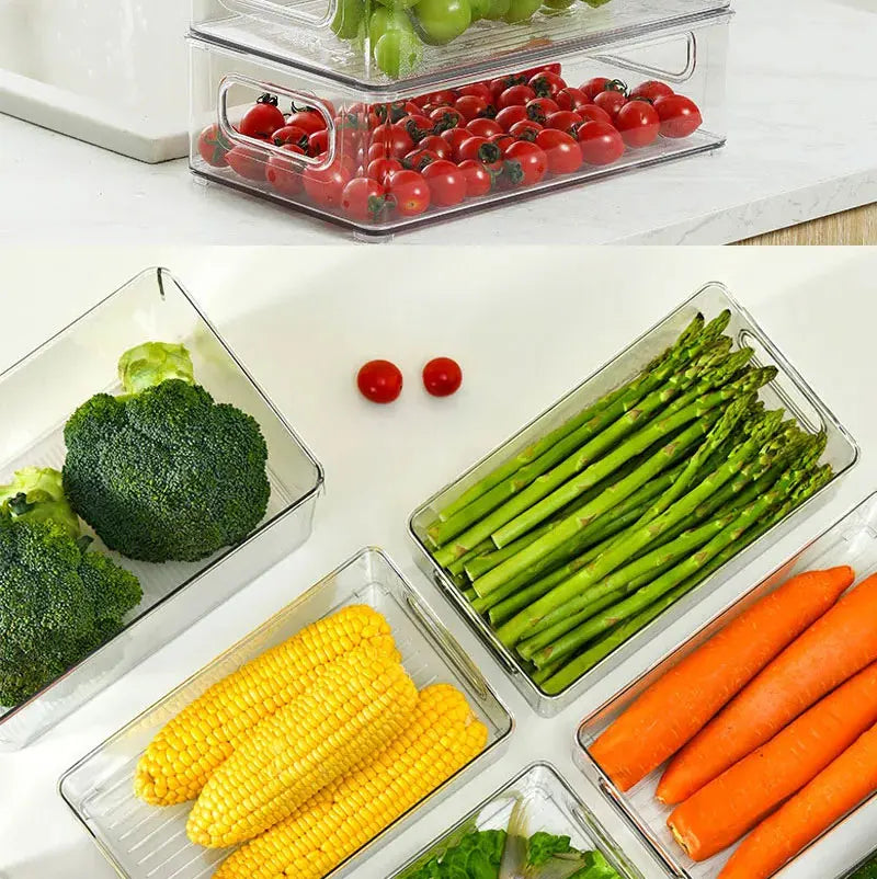 Set of clear refrigerator storage bins with built-in handles holding broccoli, corn, and carrots