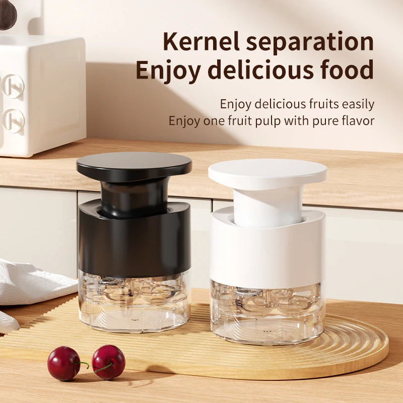 Cherry pitter with black and white lids and clear chamber for splash-free kernel separation