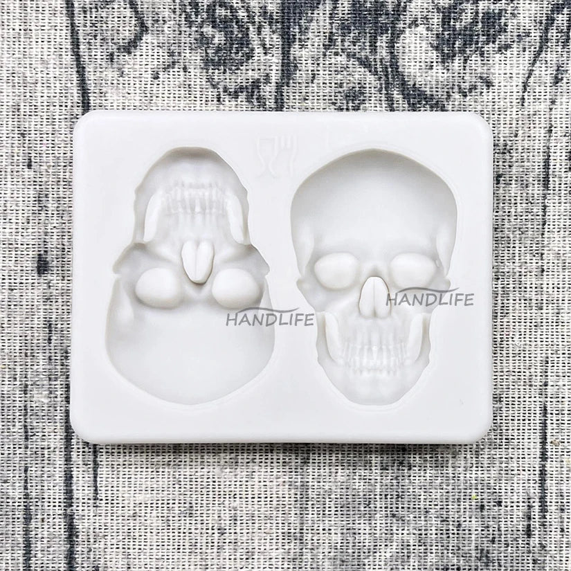 Halloween skull silicone cake mold tray with two white skull cakes in cavities