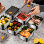 Stainless steel meal prep containers with vented lids open, holding ready-to-eat food