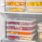 Stacked clear multi-compartment refrigerator food storage boxes with snap lids and dividers