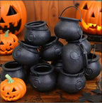 Group of black cauldron candy bowls with handles and round openings, textured finish