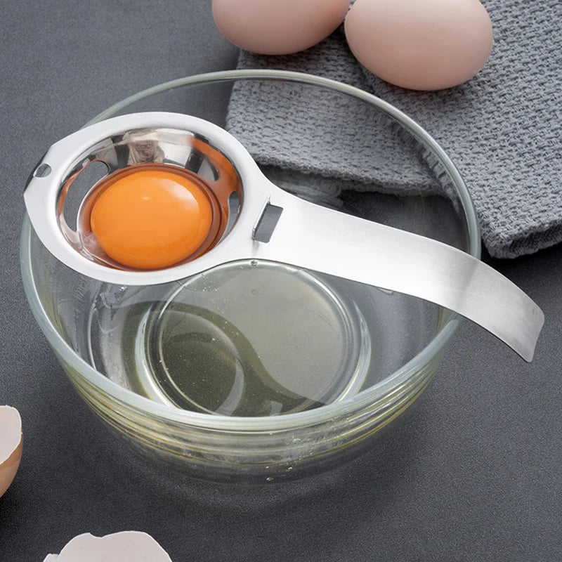 Stainless steel egg yolk and white separator with yolk cup resting on bowl rim
