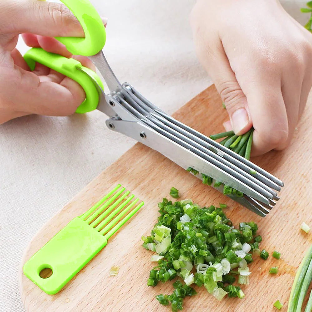 Green herb shears with stainless multi-blade head, cutting scallions on a wooden board