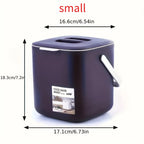 Small dark purple countertop food waste bin with hinged lid and side carry handle