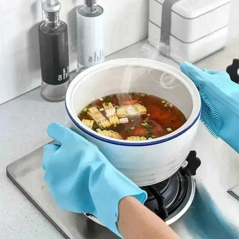 Blue silicone dishwashing scrubber glove cleaning a pot on the stovetop