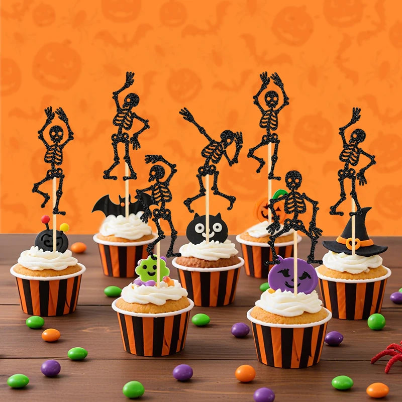 Black skeleton cupcake toppers on picks in orange Halloween cupcakes