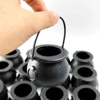 Mini black cauldron candy bowl with arched handle and round opening