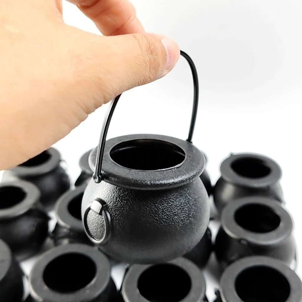 Mini black cauldron candy bowl with arched handle and round opening