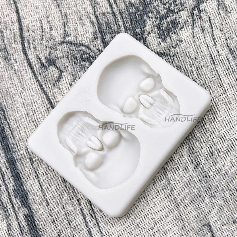 Skull silicone cake mold with two raised skull cavities and detailed facial features
