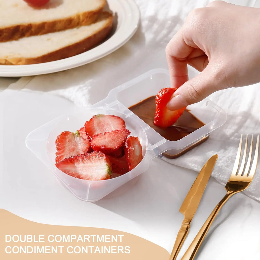 Double-compartment snack container with clear lid; hand adds strawberries and closes