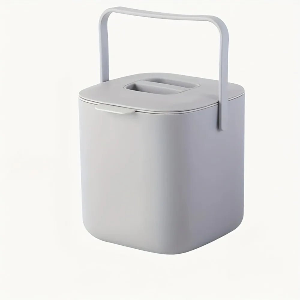 Light gray countertop compost bin with carry handle and vented lid opening