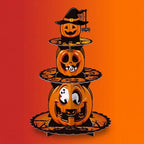 Three-tier Halloween jack-o-lantern pumpkin cupcake stand with ghost decorations and witch hat topper on orange-red gradient background.