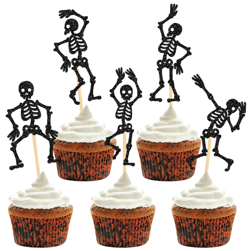 Black skeleton cupcake toppers on picks in cupcakes with white frosting