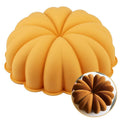 Pumpkin-shaped silicone cake pan with scalloped ridges, orange-yellow