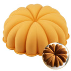 Pumpkin-shaped silicone cake pan with scalloped ridges, orange-yellow