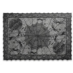 Black lace Halloween tablecloth with spider web pattern, spiders, bats, and Happy Halloween text on white background.