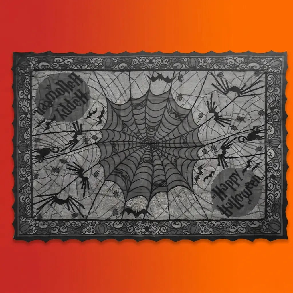 Black lace Halloween tablecloth with spider web pattern, spiders, bats, and Happy Halloween text on orange-red gradient background.