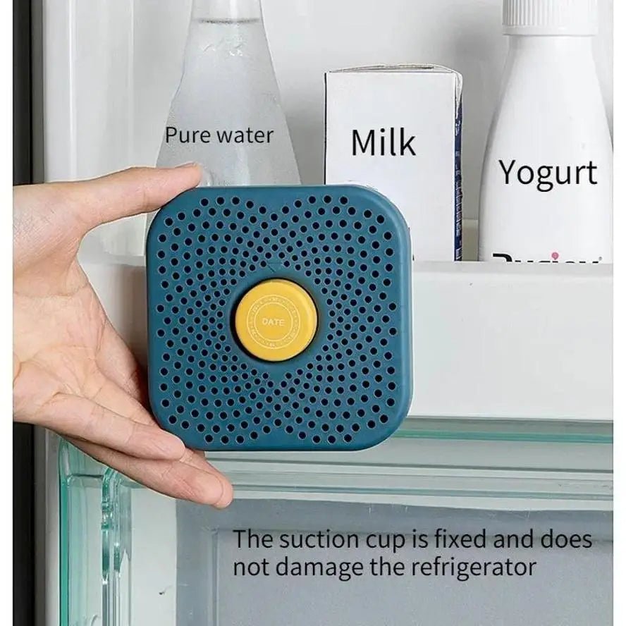 Blue refrigerator deodorizer box held in hand, showing perforations and yellow date cap