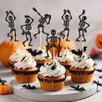 Black skeleton cupcake toppers on picks on Halloween cupcakes
