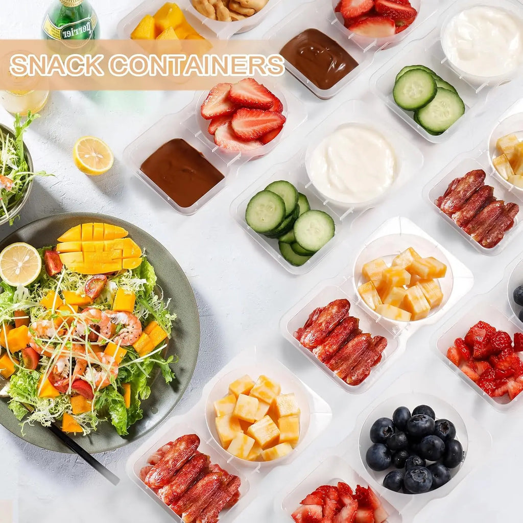 Small double-compartment snack containers holding fruit and vegetable portions, clear lids