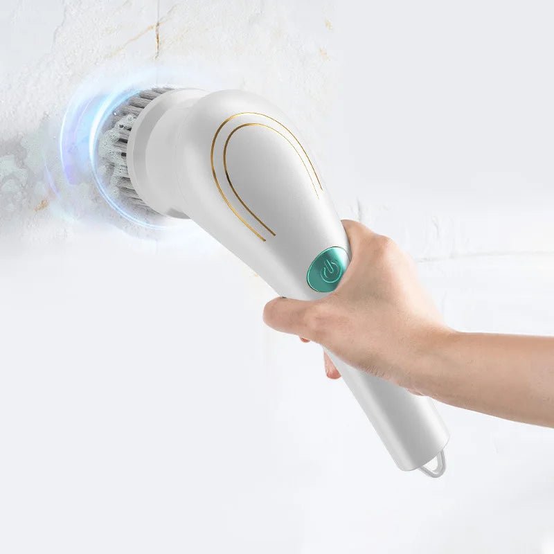 Handheld electric spin scrubber in use, rotating brush head cleaning a white surface