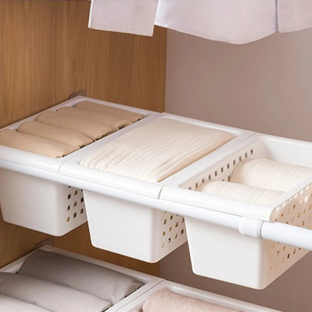 White under-sink hanging storage baskets with open tops and built-in rails