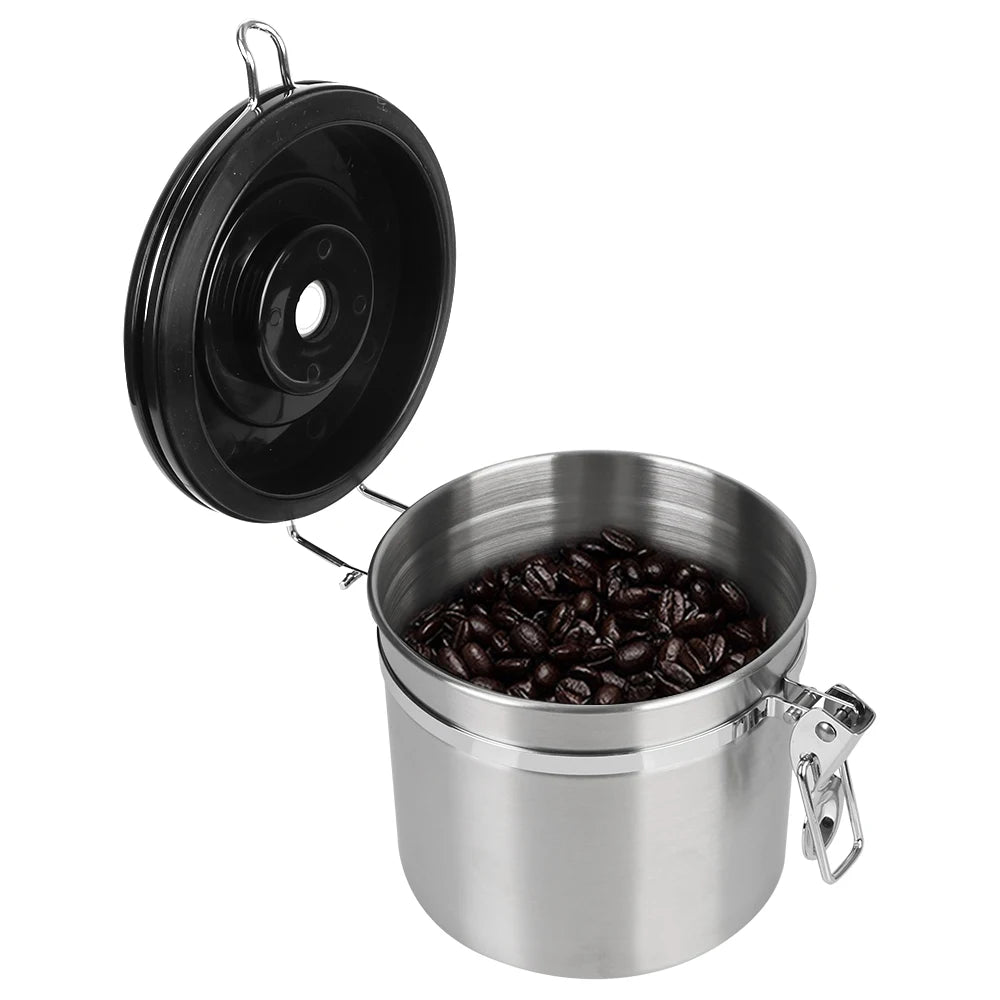 Stainless steel coffee storage canister with black lid and coffee beans, hinged on side