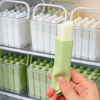 Sage green silicone ice stick tray with a hand holding a single ice stick