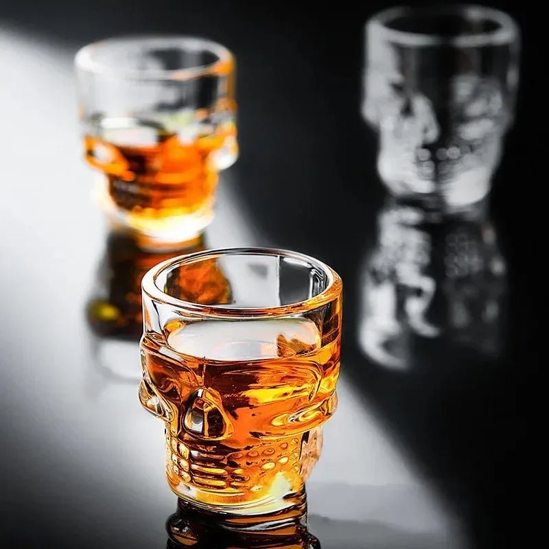 Amber skull head shot glass with raised skull face, glossy liquid fill