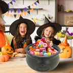 Black cauldron candy bucket with colorful candies being held by two kids wearing hats