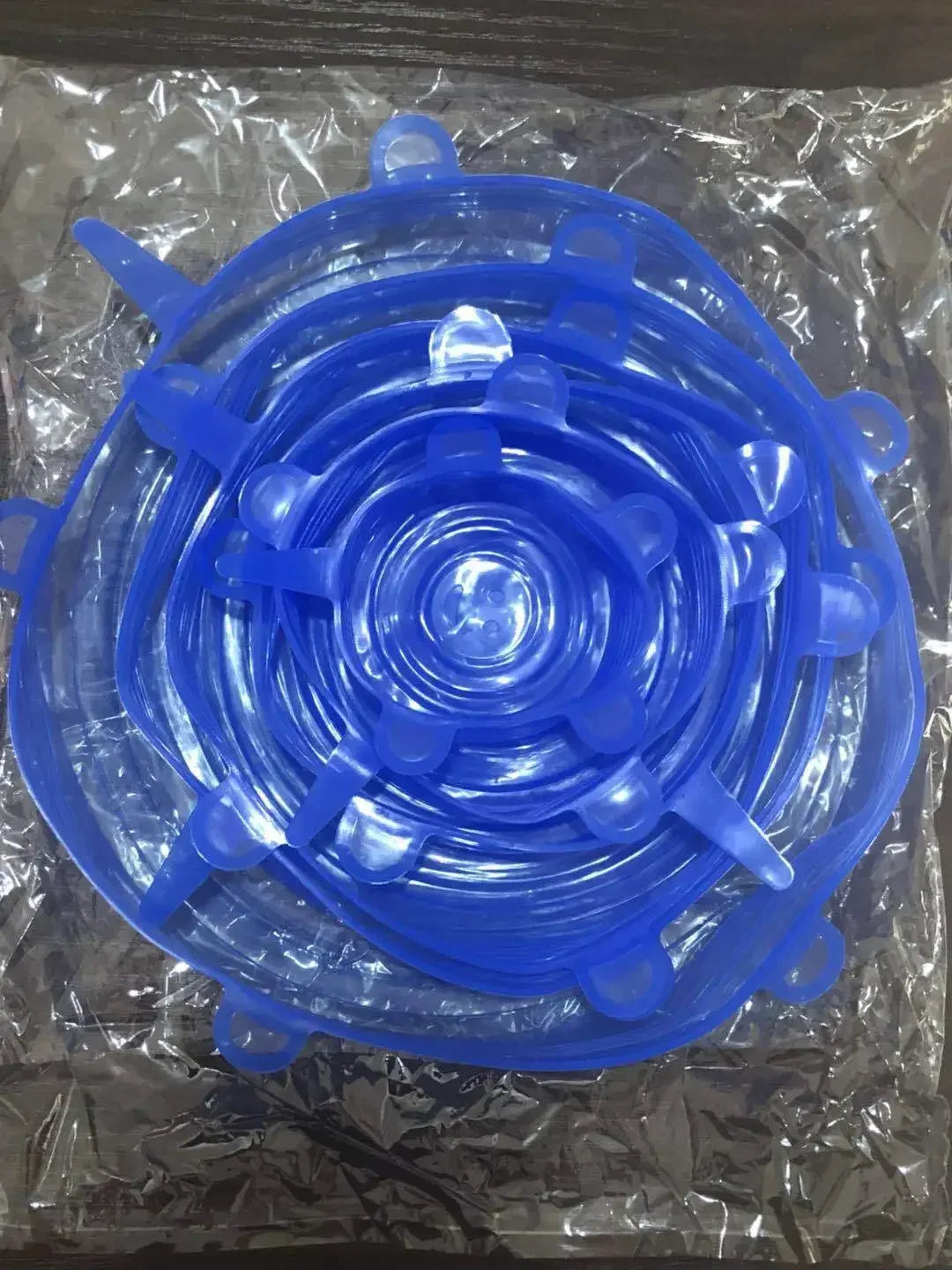 Reusable silicone stretch lids set in blue, close-up circular lids with pull tabs