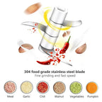 Electric mini chopper with stainless steel blade, showing chili and garlic ingredients flying.