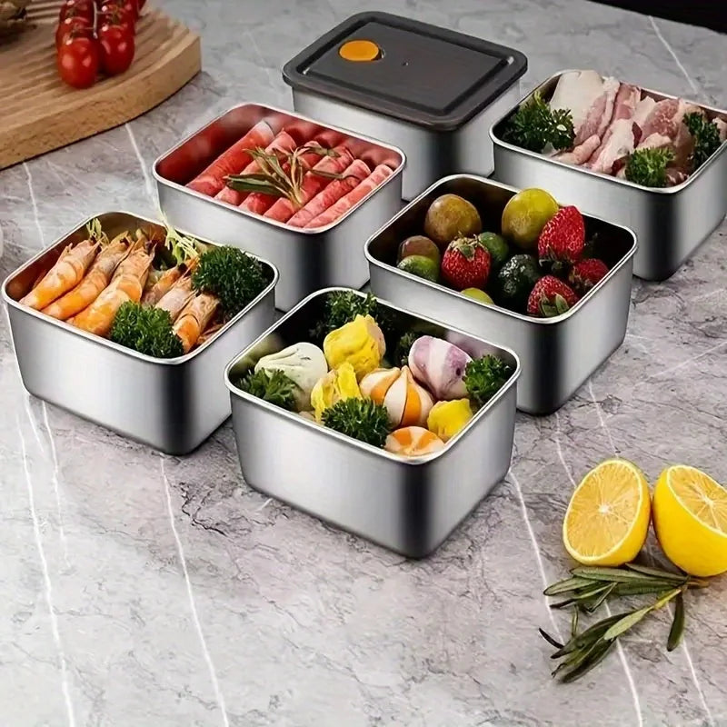 Stainless steel food storage containers set with vented lids, filled with assorted ingredients