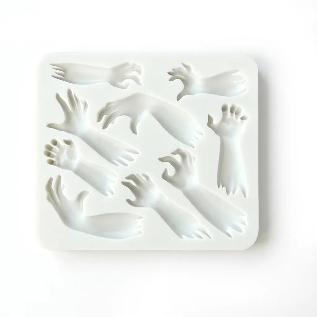 White silicone Halloween mold with multiple zombie hand and arm shapes on white background.