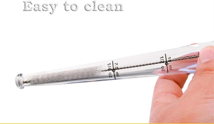 Stainless meat injector tube with measurement markings and needle tip, handheld close-up