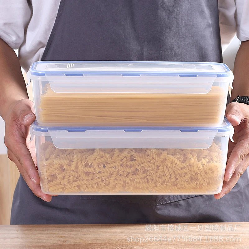 Clear airtight bread storage box with blue lid and seal, carried in both hands