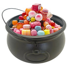 Black cauldron candy bucket filled with colorful wrapped candies, open top